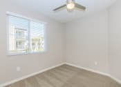 Thumbnail 27 of 72 - an empty bedroom with a ceiling fan and a window