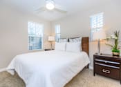 Thumbnail 45 of 60 - a bedroom with a large white bed and a ceiling fan