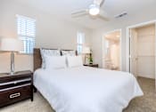 Thumbnail 51 of 60 - a bedroom with a large white bed and a ceiling fan