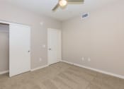 Thumbnail 26 of 72 - a empty bedroom with a ceiling fan and a closet