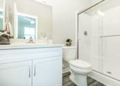 Thumbnail 55 of 60 - a white bathroom with a shower and a toilet