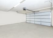 Thumbnail 60 of 60 - an empty garage with a white wall and a white garage door