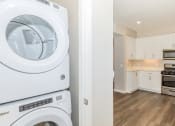 Thumbnail 34 of 72 - a white washer and dryer in a kitchen with white cabinets