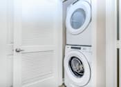 Thumbnail 58 of 60 - a white washer and dryer in a laundry room with a door