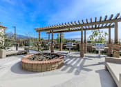 Thumbnail 37 of 60 - a patio with a fire pit and benches and a pergola