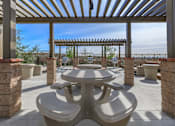 Thumbnail 42 of 60 - a patio with tables and chairs and a pergola