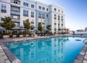 Thumbnail 3 of 33 - a large swimming pool in front of an apartment building