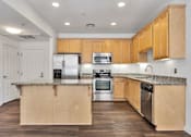 Thumbnail 37 of 40 - A kitchen with wooden cabinets and stainless steel appliances.