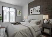 Thumbnail 16 of 44 - Apartments Near Santana Row - Vendome Place - Bedroom with Carpeted Flooring, Exposed Concrete Accent Wall, Large Bed, Nightstands with Lamps, Potted Plant, and Spacious Window.