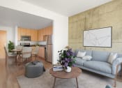 Thumbnail 8 of 44 - Apartments in Downtown San Jose, CA for Rent - Vendome Place - Open Floor Plan Living Area with Luxury Vinyl Tile Flooring, Area Rug, Exposed Concrete Accent Wall, Sofa, Ottoman, Round Coffee Table, and View of Kitchen and Dining Area.