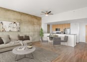 Thumbnail 11 of 44 - Living room with concrete accent wall and kitchen at Vendome Place, San Jose