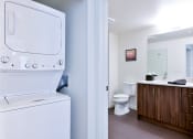 Thumbnail 33 of 33 - a washer and dryer in a bathroom with a toilet and a sink