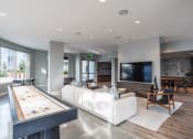 Thumbnail 15 of 33 - a large living room with a white couch and a pool table