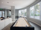 Thumbnail 16 of 33 - a shuffleboard table in the center of a living room with large windows
