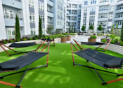 Thumbnail 21 of 33 - an image of the hammocks on the lawn of an apartment building