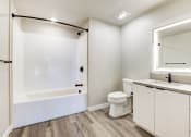 Thumbnail 7 of 18 - a bathroom with a toilet and a tub and a sink