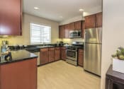 Thumbnail 30 of 46 - Townhomes for rent in Roseville, CA - Adora - Kitchen with Stainless-Steel Appliances and Granite Countertops
