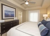 Thumbnail 33 of 46 - a bedroom with a large bed and a ceiling fan