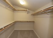 Thumbnail 37 of 46 - a spacious walk in closet with shelves and a light