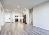 Thumbnail 5 of 18 - the living room and kitchen of a new home with white walls and wood flooring