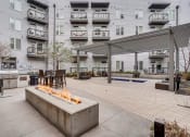 Thumbnail 30 of 34 - Firepit And Grill Area Near The Spa With Tables And Chairs at Waterford RiNo, Denver, 80216