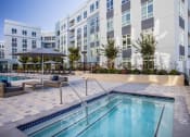 Thumbnail 5 of 33 - a swimming pool with a building in the background