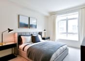 Thumbnail 32 of 33 - a bedroom with a bed and a large window