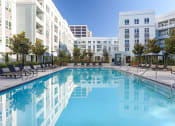 Thumbnail 6 of 33 - a swimming pool with a building in the background