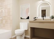 Thumbnail 44 of 117 - A bathroom with a white tub, toilet, and sink at Skyview Sunset Apartments, Los Angeles, CA, 90046