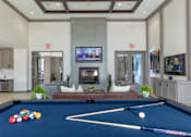 Thumbnail 27 of 62 - Clubroom with seating area and fireplace at The Grove Apartments, California