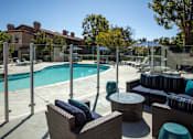 Thumbnail 9 of 57 - Seating area adjacent to pool with glass partition fence at Pointe Niguel, Laguna Niguel, 92677