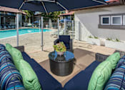 Thumbnail 15 of 57 - Seating area adjacent to pool with glass partition fence at Pointe Niguel, Laguna Niguel, CA