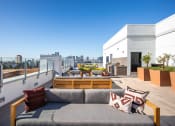 Thumbnail 8 of 33 - a roof top patio with a couch and a view of the city