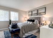 Thumbnail 1 of 27 - A bedroom with a large bed and a bench in front of it at Nola 624 Apartments, West Covina, 91790