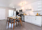 Thumbnail 6 of 27 - A kitchen with a table and chairs in the middle of it at Nola 624 Apartments, West Covina