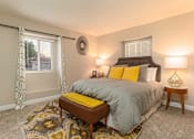 Thumbnail 11 of 27 - A bedroom with a bed, nightstand, and window with curtains at Nola 624 Apartments, West Covina, 91790
