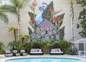 Thumbnail 5 of 39 - a mural of a peacock on the side of a building with lounge seating by the pool at Vera Cortez Hill, San Diego, 92101