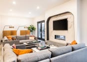 Thumbnail 14 of 30 - a living room with couches and a fireplace and a television