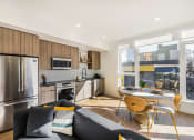Thumbnail 2 of 30 - a kitchen with stainless steel appliances and a table and chairs