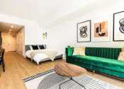 Thumbnail 10 of 30 - a living room with a couch and a bed