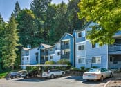 Thumbnail 25 of 73 - Building exterior with carport and parking at Lakemont Orchard, Issaquah, 98027  