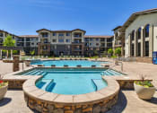 Thumbnail 6 of 39 - Resort-Style Swimming Pool with Hot Tub, Fountain, and Lounge Chairs at Terracina, Broomfield, Colorado