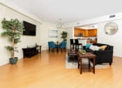 Thumbnail 13 of 75 - a living room with hardwood floors and a large screen tv on the wall