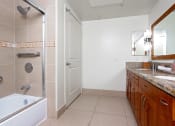 Thumbnail 18 of 75 - a bathroom with a bathtub and a sink