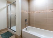 Thumbnail 30 of 75 - a bathroom with a bathtub and a shower