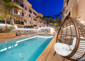 Thumbnail 35 of 75 - Nightime pool shot with lounge seating