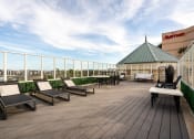 Thumbnail 52 of 75 - a rooftop deck with lounge chairs