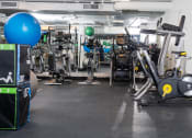 Thumbnail 41 of 75 - a gym with a lot of exercise machines and weights