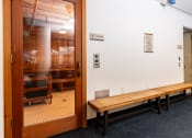 Thumbnail 62 of 75 - a room with a wooden bench and a glass door