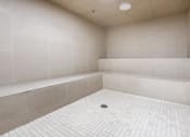 Thumbnail 64 of 75 - a white tiled bathroom with a shower and a tub